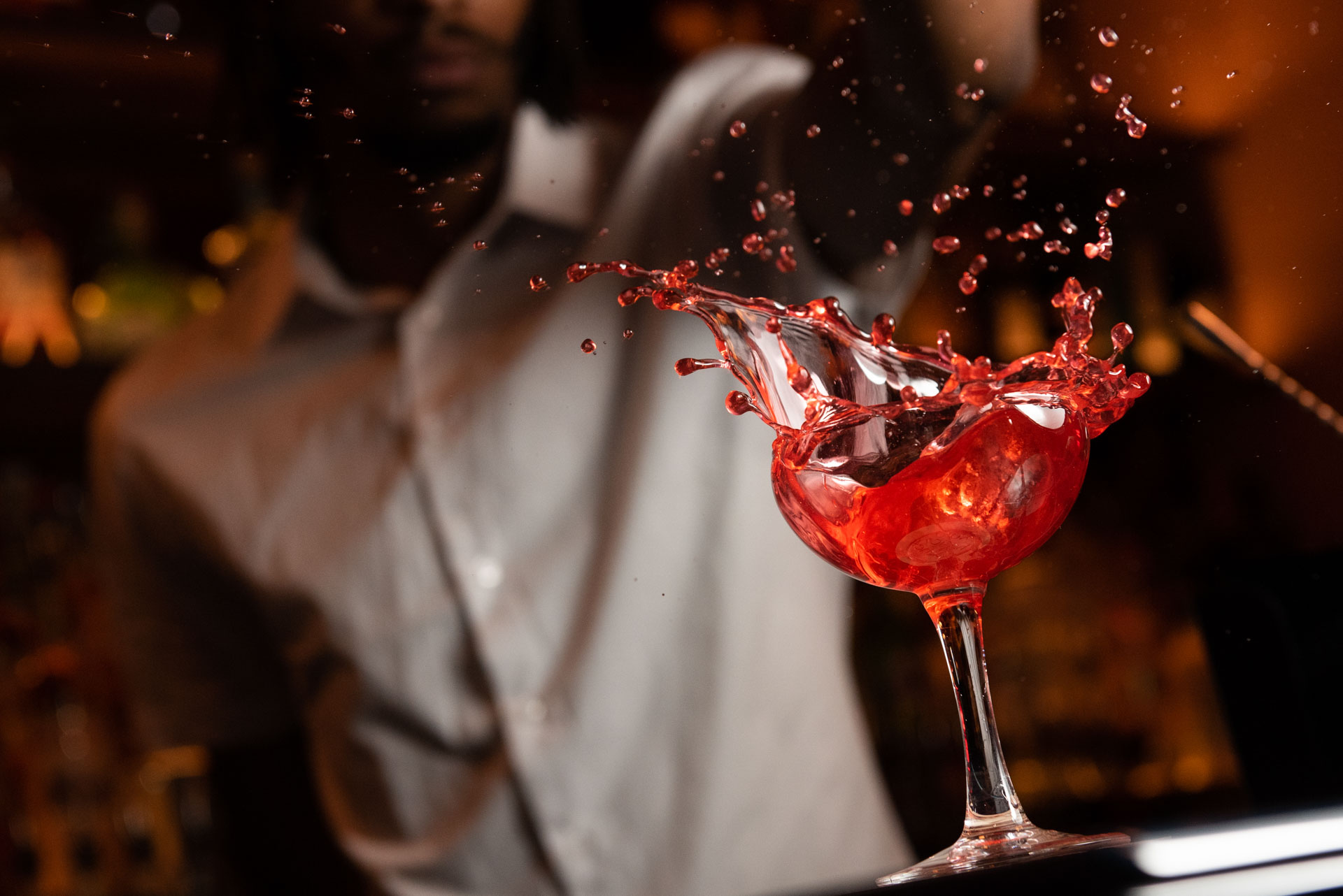 Cocktail Artistry - Red cocktail splashing in elegant glass
